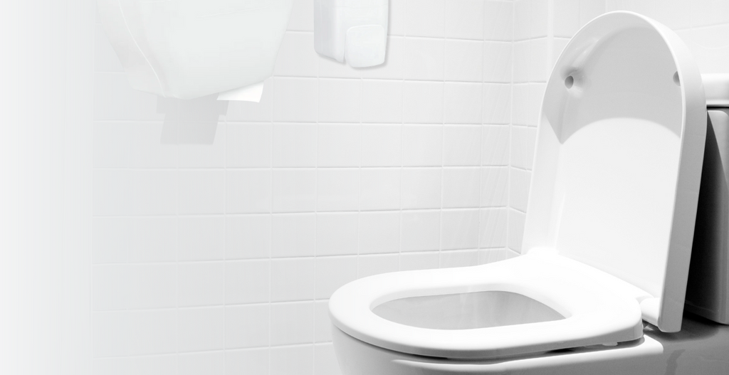 A clean washroom cubicle with a stocked Initial toilet paper dispenser.
